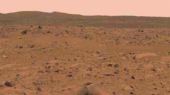 This image, cropped from a larger panoramic image mosaic taken by the Mars Exploration Rover Spirit panoramic camera, released by in March 2004, shows the rover's destination toward the hills nicknamed the "Columbia Hills." 